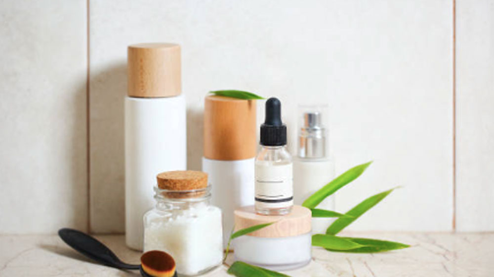 Face cream, serum, lotion, moisturizer and sea salt  among bamboo leaves in the bath product photography