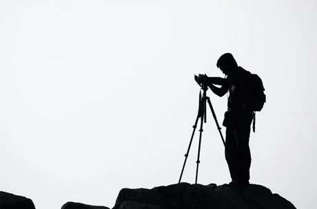 Silhouette of Man Holding Camera