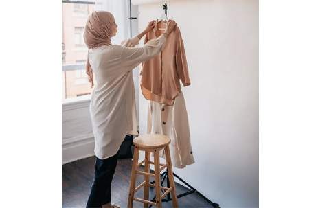 Woman Wearing Hijab Hanging Clothes